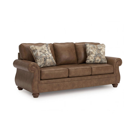 Signature Design by Ashley Shadsburne Rustic Faux Leather Sofa with Nailhead Trim and 2 Throw Pillows, Brown