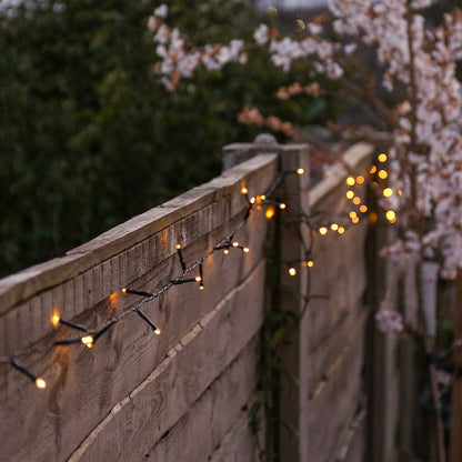 Festive Lights - 10m Solar Power Multi Function Fairy String Lights with 100 Warm White LEDs - IP44 Rated, Outdoor Decorative Lighting - External Panel, Black Cable, Garden Trees, Fences & Pergolas