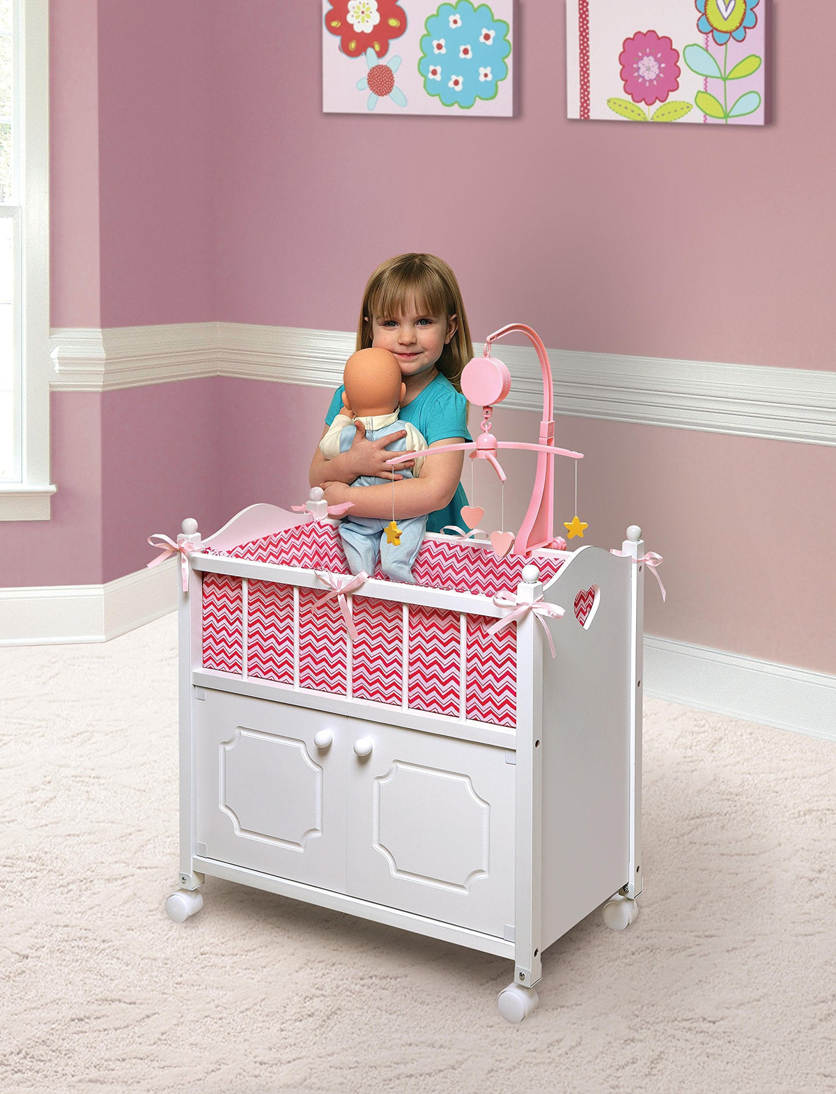 Badger Basket Wooden Toy Doll Bed with Storage, Mobile, and Bedding - Includes Wheels and Free Personalization Kit to Pretend and Play - White with Pink Chevron Fabric